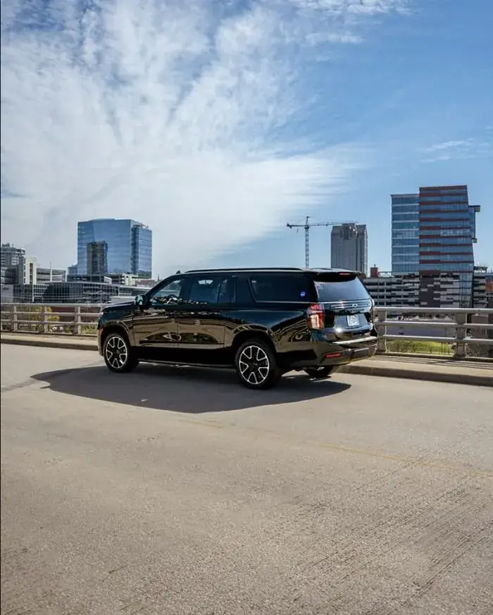 Sleek Transportation fleet vehicle with downtown Raleigh skyline