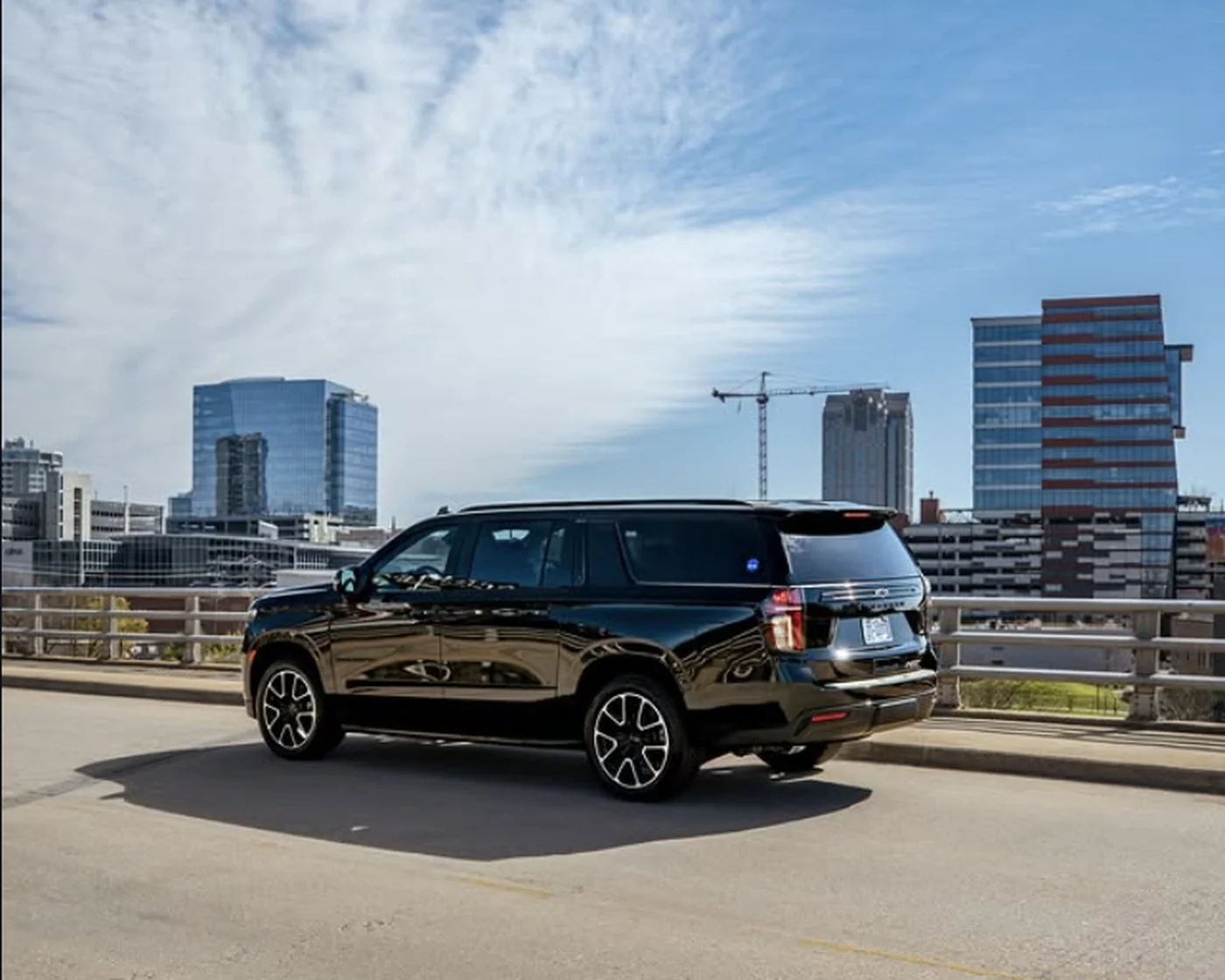 Sleek Transportation fleet vehicle with downtown Raleigh skyline