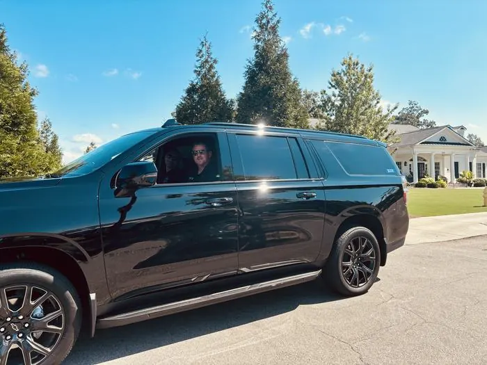 Sleek Transportation Suburban with chauffeur and client