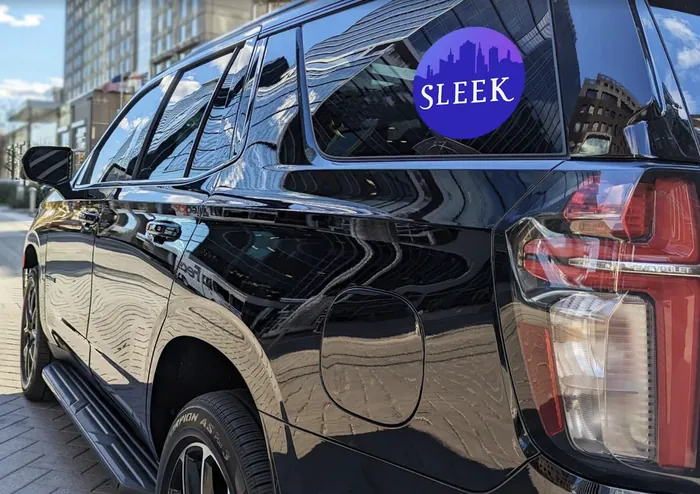 Sleek Transportation vehicle with Sleek logo in downtown Raleigh